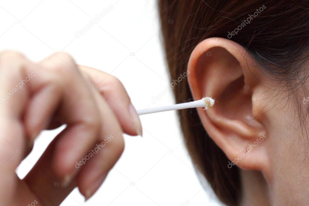 Removing ear wax using a cotton bud                                 