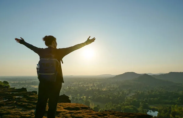 happy woman in the mountains at sunrise