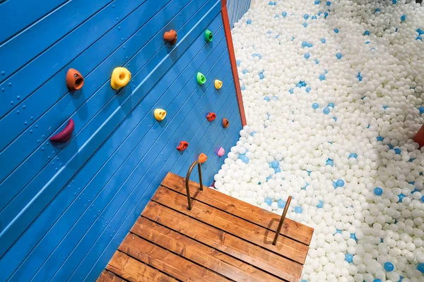 Rock climbing holds for kids with ball pit