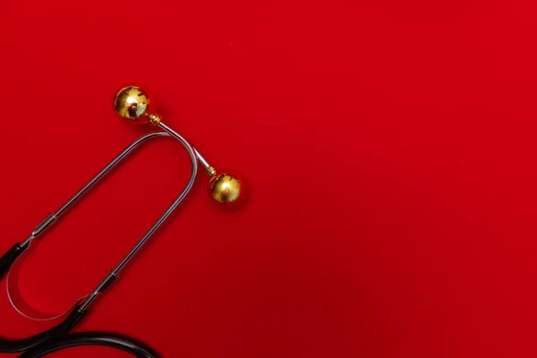 Medical Christmas banner with stethoscope on red background.