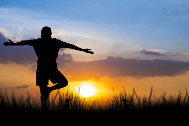 Gün batımında Siluet Asya kadın yoga.