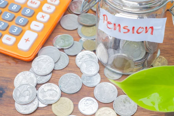 Coins in glass money jar with pension label — Stock Photo, Image