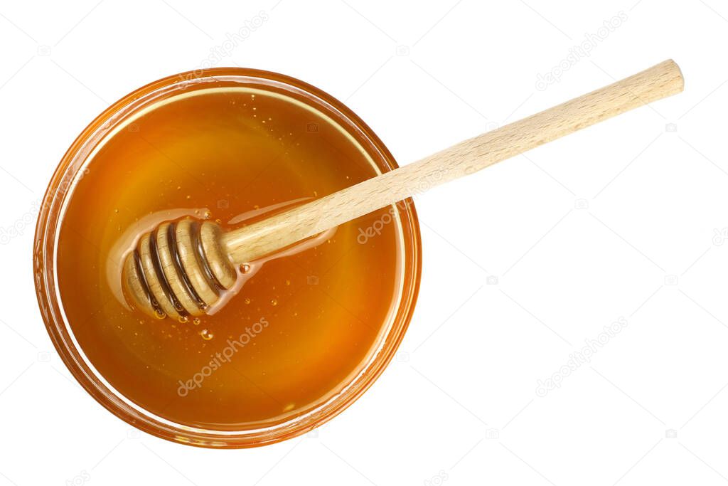 Honey in a bowl with a wooden stick isolated on a white background