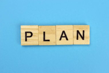 Mavi arka planda ahşap harflerden oluşan bir kelime planla
