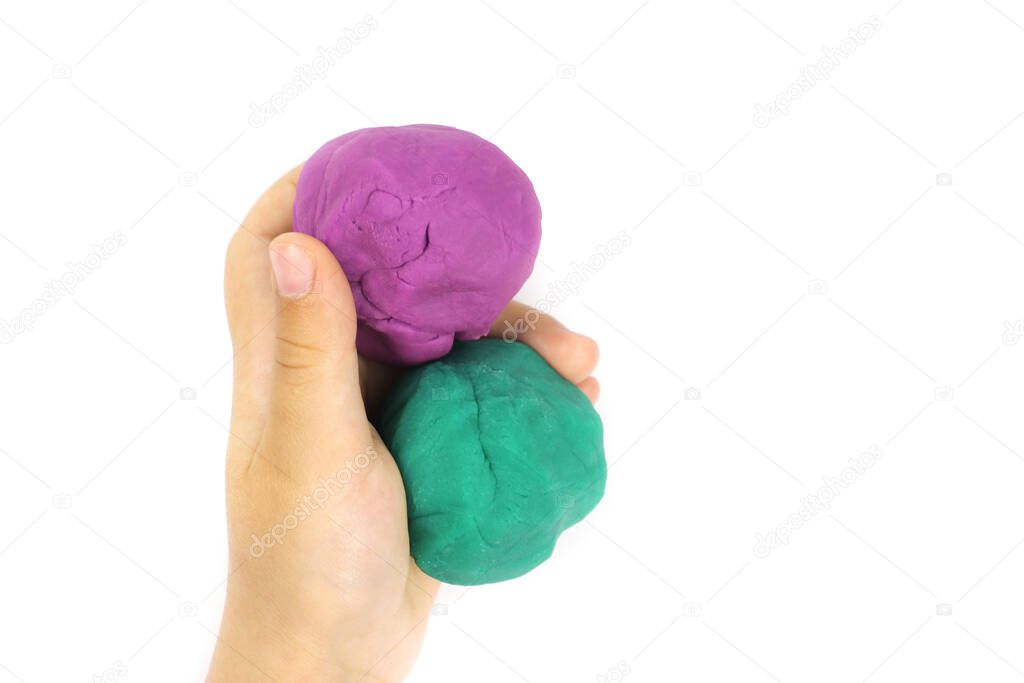 modeling clay, plasticine a child holds in hands