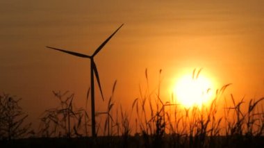 Silhouette of wind turbine over sunset ecology energy concept for electric maker the technology of alternate clean power form wind