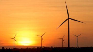 Silhouette of wind turbine over sunset ecology energy concept for electric maker the technology of alternate clean power form wind