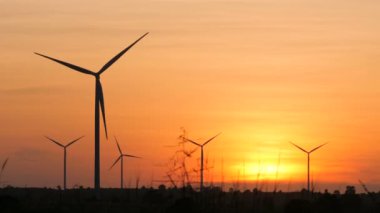 Silhouette of wind turbine over sunset ecology energy concept for electric maker the technology of alternate clean power form wind