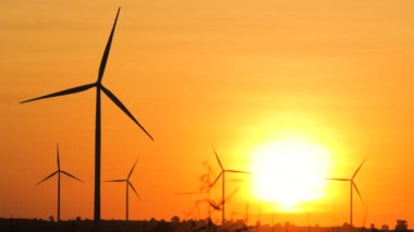 Silhouette of wind turbine over sunset ecology energy concept for electric maker the technology of alternate clean power form wind