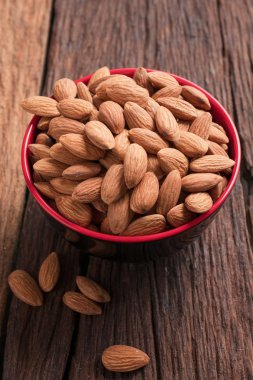 Ahşap masaya karşı seramik kasede badem somun