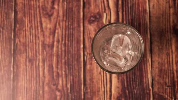 Time Lapse Shot Ice Dissolving Clear Glass Wooden Table Select — Stock Video