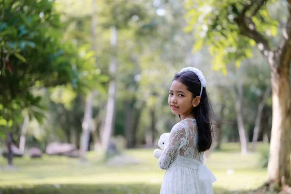Portrét malé asijské dívky usmívající se v přírodním lese s — Stock fotografie