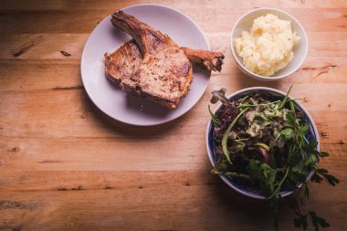 Izgara biftek, sebze ve patates püresi ve ahşap arka plan.