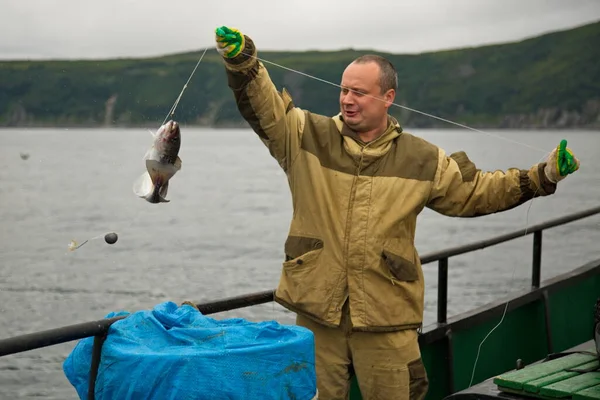 Fisherman at work, Sea of Okhotsk.