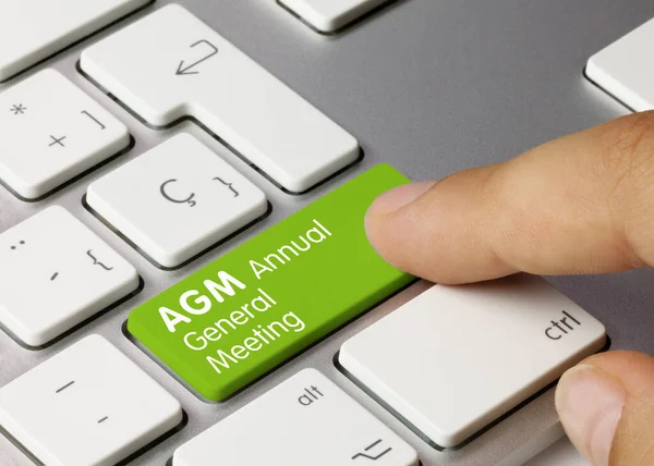 关于金属键盘绿色键的Agm年度大会 手指按键 — 图库照片
