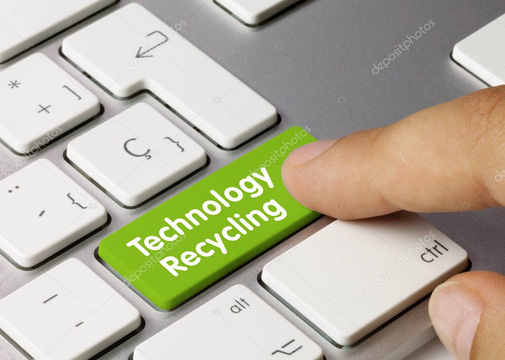 Technology Recycling Written on Green Key of Metallic Keyboard. Finger pressing key.