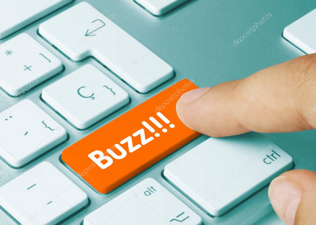 Buzz!!! Written on Orange Key of Metallic Keyboard. Finger pressing key.