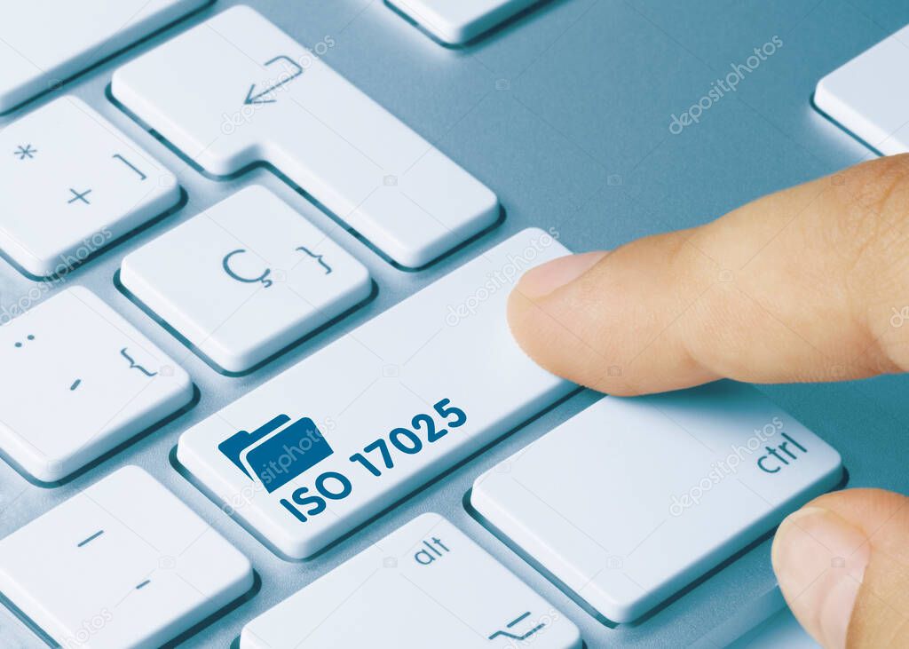 ISO 17025 Written on Blue Key of Metallic Keyboard. Finger pressing key.