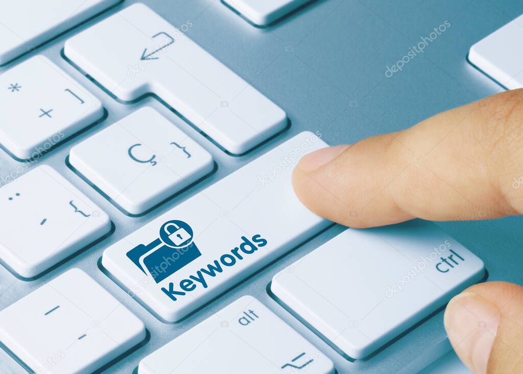 Keywords Written on Blue Key of Metallic Keyboard. Finger pressing key.