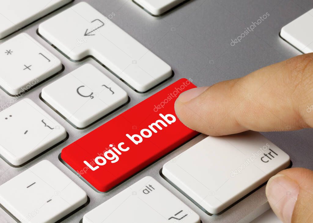 Logic bomb Written on Red Key of Metallic Keyboard. Finger pressing key.
