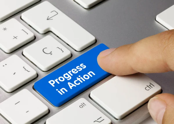 Progress Action Written Blue Key Metallic Keyboard Finger Pressing Key — Stock Photo, Image