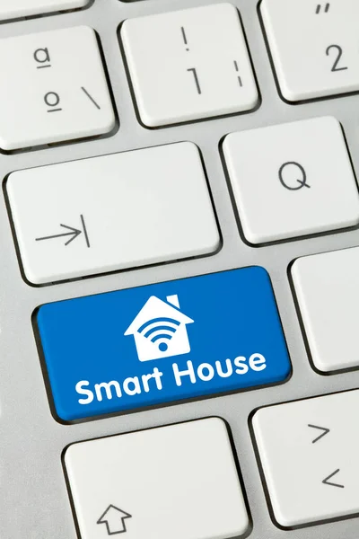 Smart House Written on Blue Key of Metallic Keyboard. Finger pressing key.