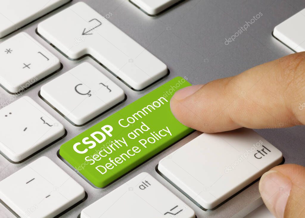 CSDP Common Security And Defence Policy Written on Green Key of Metallic Keyboard. Finger pressing key.