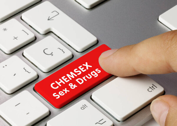 CHEMSEX Sex & Drugs Written on Red Key of Metallic Keyboard. Finger pressing key.