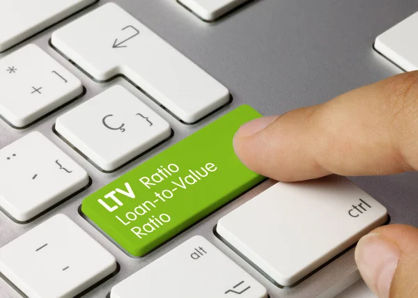 stock image LTV Ratio Loan-to-Value Ratio Written on Green Key of Metallic Keyboard. Finger pressing key.