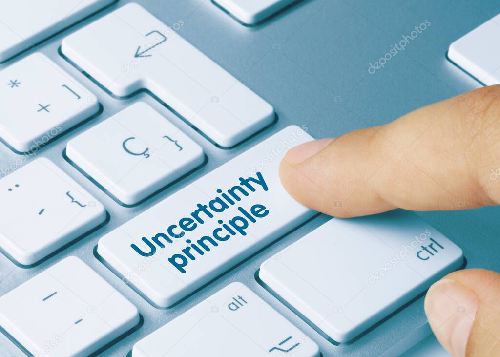 uncertainty principle Written on Blue Key of Metallic Keyboard. Finger pressing key.