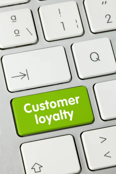 Customer loyalty Written on Green Key of Metallic Keyboard. Finger pressing key.