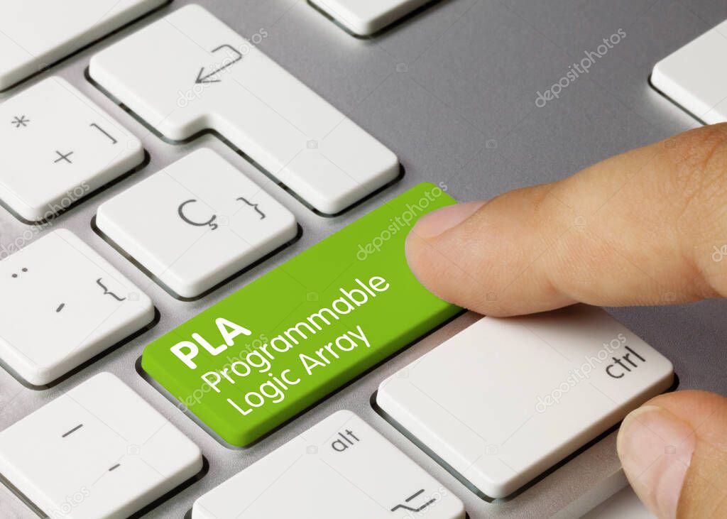 PLA Programmable Logic Array Written on Green Key of Metallic Keyboard. Finger pressing key.