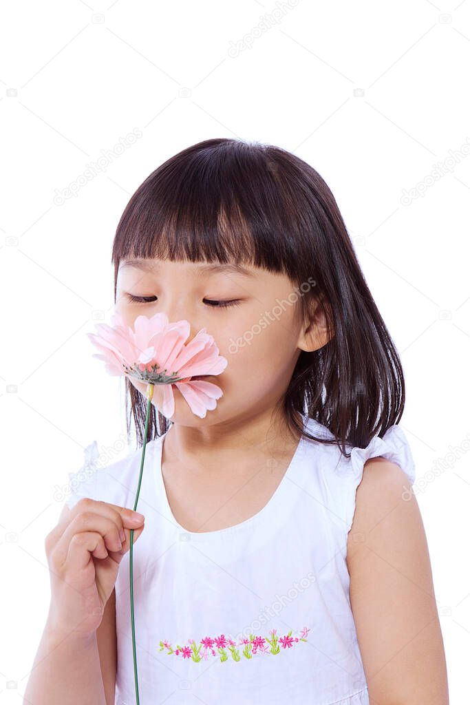 A little girl smelling flower,portrait
