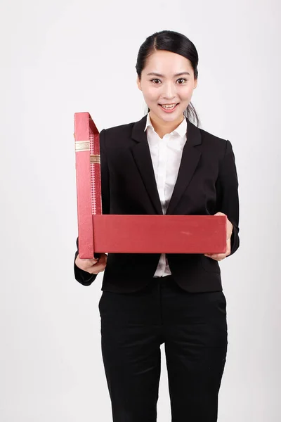 A business woman carrying a gift box