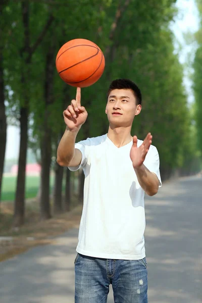 The young man playing basketball