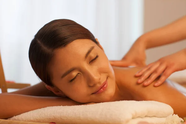 Young woman is getting oil massage in spa salon. Body care and beauty concept