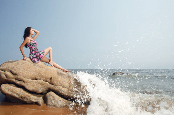 	Young woman by the sea	 