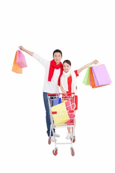 Retrato Pareja Joven Empujando Carrito Compras Con Bolsas Compras Brazos —  Fotos de Stock