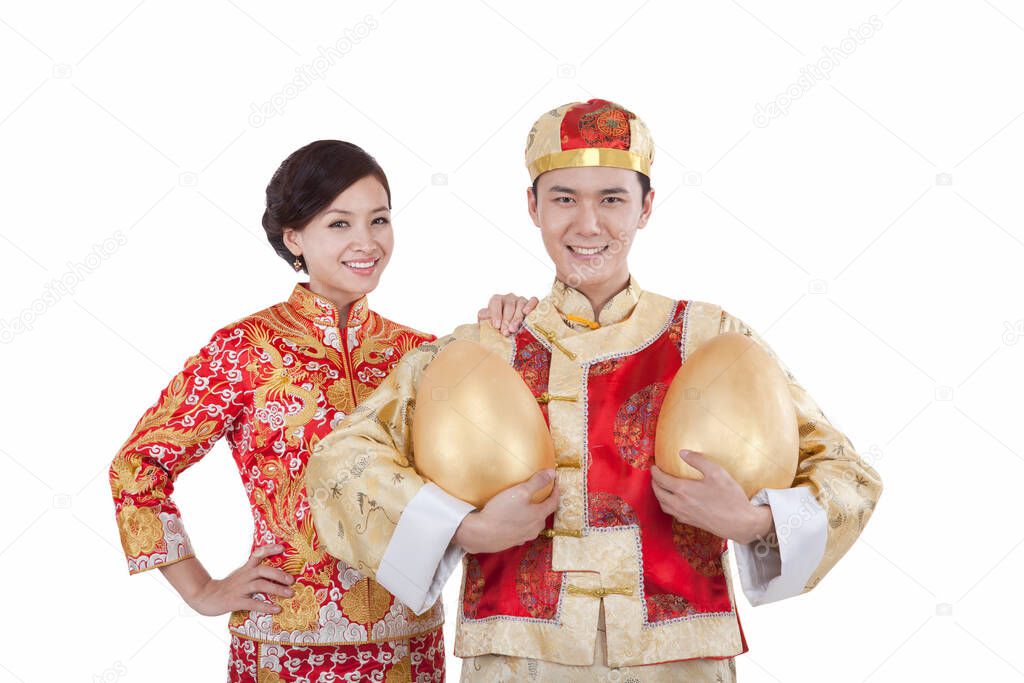 	Portrait of young couple in Tang suits holding Jin Dans	