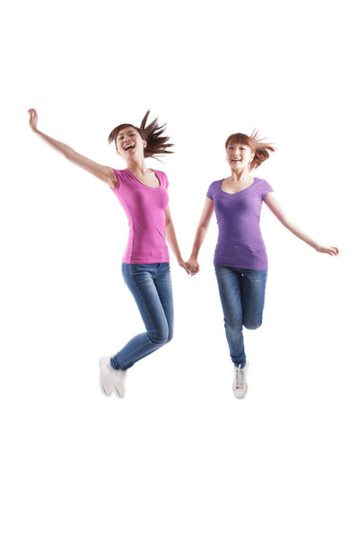 	Portrait of two female friends jumping	