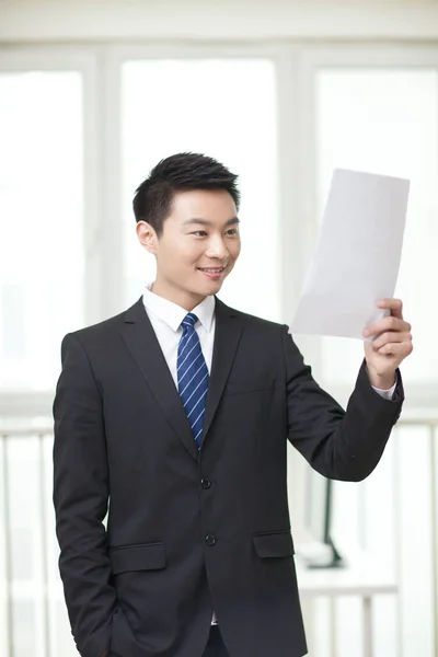 Portrait Young Businessman Standing Looking Documents Holding — Stock Photo, Image