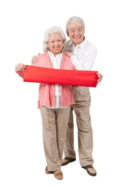 Senior Couple Holding Red Streamer — Stock Photo, Image