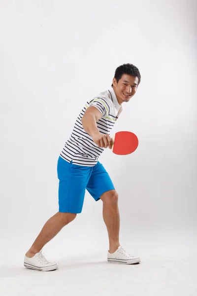 一个穿着休闲装打乒乓球的年轻人 — 图库照片