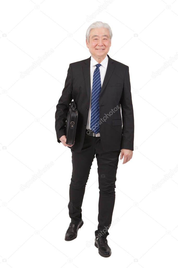 	Senior businessman with briefcase 	