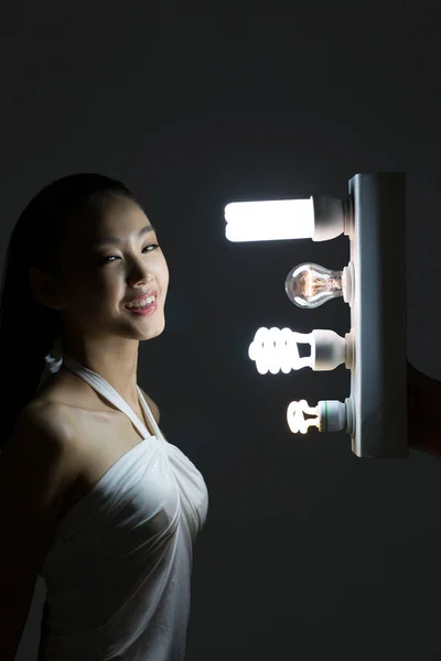 Young woman and a light bulb