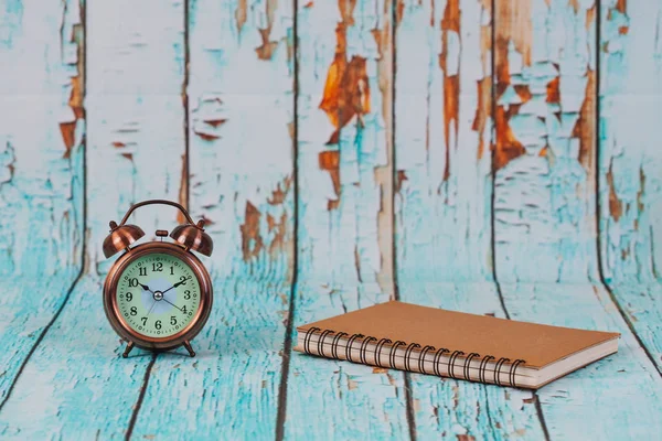 old alarm clock on old wood background