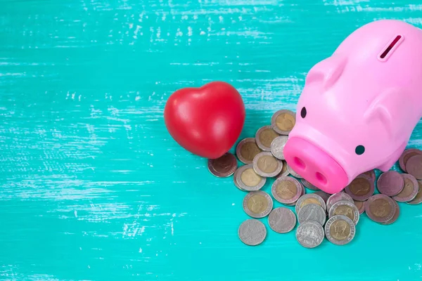 pink piggy bank over coins stack, saving money concept