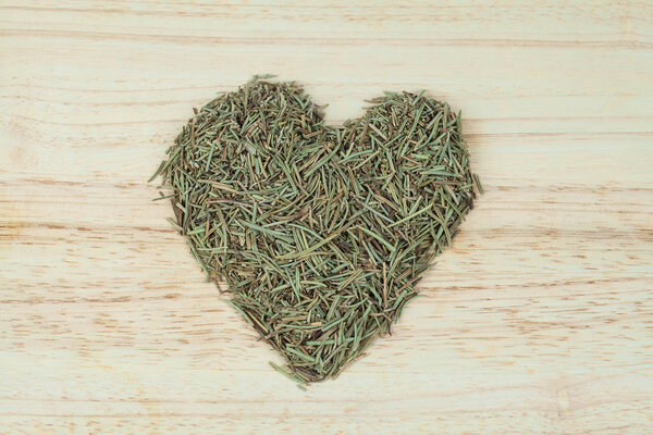 dry rosemary herb on texture background.