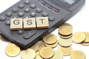 Word Gst ahşap alfabe bloklar üzerinde hesap makinesi. Seçici odak alan sığ derinliği. Maliye ve vergi kavramları.
