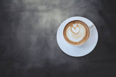 Siyah renk arka plan üzerinde Latte sanat kahve kalp işareti.